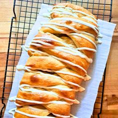 a loaf of bread with white icing on a cooling rack