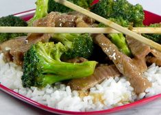 beef and broccoli with rice in a red bowl