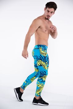 Description: Blue & Green Tiger Print Men’s Performance Leggings Compression Level: Light to Medium Sweat-wicking Poly / Spandex with 4-Way Stretch Bounce-Proof Phone Pocket Zip Pocket For Cash & Keys Ergonomic Waistband Adjustable Drawstring Flat Seams Sports Gusset Embroidered Bolt Logo Machine wash cold, quick drying Model is 6’2’’ (189cm) tall, 34’’ (86cm) waist size and wears size Large. Blue Sportswear Pants For Running, Blue Fitted Bottoms For Running, Casual Blue Running Pants, Casual Blue Leggings For Running, Blue Elastane Training Pants, Summer Gym Blue Leggings, Blue Tight Pants For Training, Tight Blue Training Pants, Blue Tight Training Pants