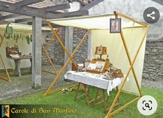 a table with pictures on it in front of a building and an awning over it