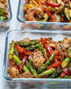 three glass containers filled with different types of vegetables and meat on top of a table