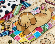 a dog laying on top of a colorful blanket