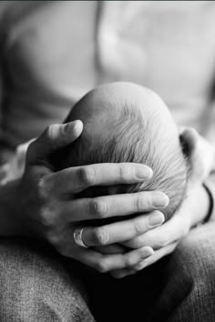 a person holding a baby in their hands