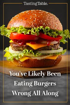 a hamburger with lettuce, tomato and cheese on it that says you've likely been eating burgers wrong all along