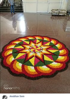 a large flower design on the ground in an airport