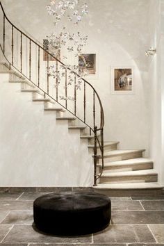 a room with stairs and a round table in the middle, on pinterest