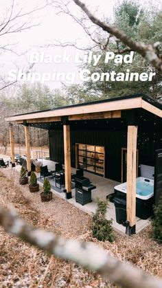 an outdoor hot tub in the middle of a wooded area with tables and chairs around it