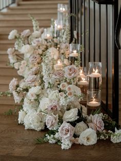 flowers and candles are lined up on the stairs