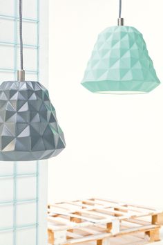 two different colored lamps hanging from the ceiling