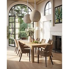 a dining room table with chairs and vases on it