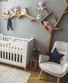 a baby's room with grey walls and white furniture