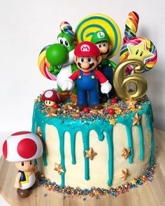 there is a birthday cake with mario and friends on it