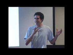 a man standing in front of a projector screen giving a presentation to someone else