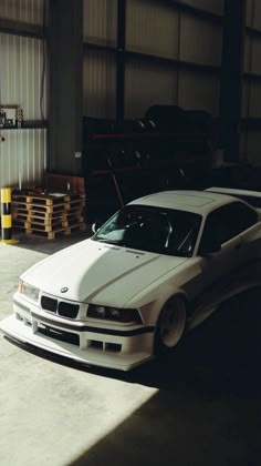 a white car is parked in a garage