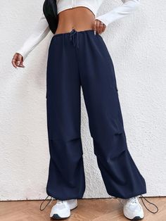 Whether you're strolling through city streets or attending a social gathering, these Drop Waist Regular Fit Parachute Pants will undoubtedly become a staple in your wardrobe. Make a statement without uttering a word as you grace any occasion with an air of sophistication and an unmistakable edge. Embrace the fashion-forward spirit and stride confidently, knowing that you are a trendsetter in your own right. Specifications: Style: Casual Pattern Type: Plain Type: Parachute Pants Closure Type: Dra Non-stretch Blue Pants For Streetwear, Blue Pants For Streetwear, Stretch Blue Pants With Cargo Pockets, Blue Stretch Pants With Cargo Pockets, Blue Stretch Wide Leg Cargo Pants, Trendy Baggy Blue Parachute Pants, Trendy Blue Baggy Parachute Pants, Blue Cargo Pocket Bottoms For Fall, Blue Cargo Bottoms For Fall