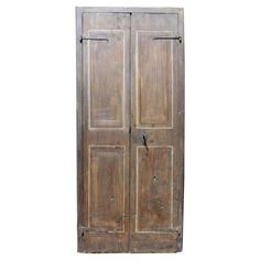 an old wooden door with two doors on each side