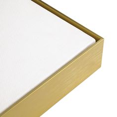 a close up view of a mattress in a gold and white bed frame with no sheets on it