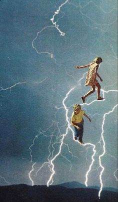 two people are flying through the air with lightning in the background and one person is jumping