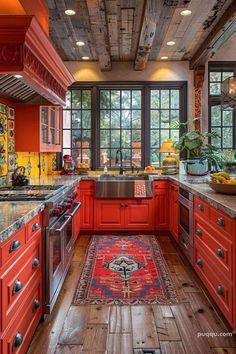 an orange kitchen with wood floors and red painted cabinets is featured in this photo by the photographer