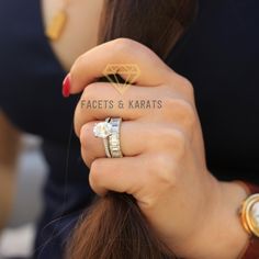 a woman with two rings on her fingers and the words facets & karats written on her finger