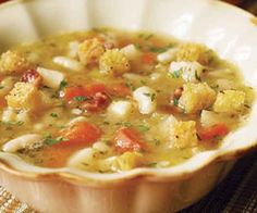 a white bowl filled with soup on top of a table