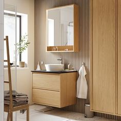 a bathroom with a sink, mirror and towel rack