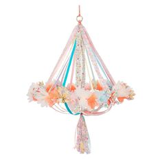 a colorful chandelier with flowers and ribbons hanging from it's sides on a white background