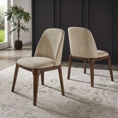 two chairs sitting on top of a white rug