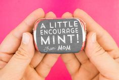 two hands holding a small rock that says, a little entourage mint from mom