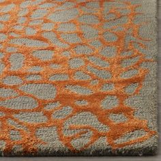 an orange and gray rug on the floor