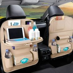 the back seats of a car with two laptops and other items in their holders