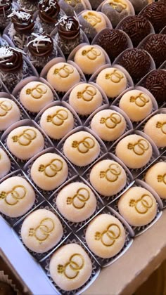 many different types of cupcakes on display in trays