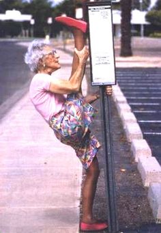 an older woman leaning up against a sign with the words you're never too old to have fun live your life as if you're forever forever forever forever