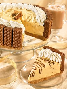 there are three different desserts on the glass platter and one has a slice missing