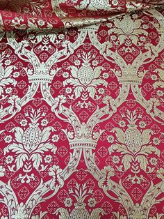 red and gold wallpaper with white designs on it