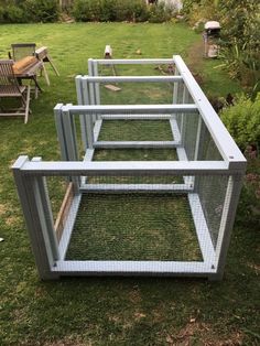 three chicken coops sitting in the grass