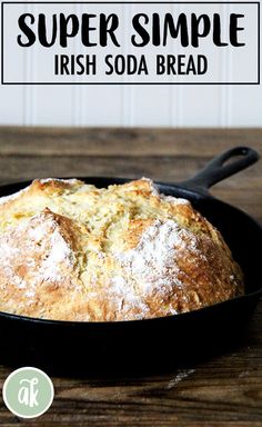 a loaf of irish soda bread in a cast iron skillet on a wooden table