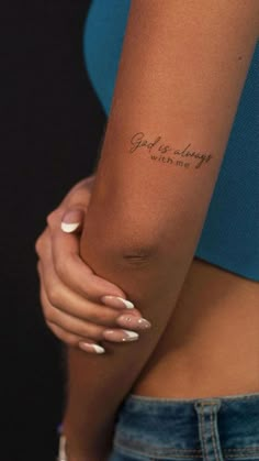 a woman's arm with a tattoo that reads, god is always waiting for me