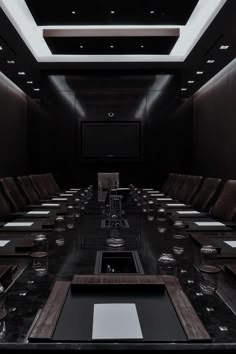 an empty conference room with long tables and chairs