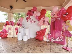 balloons and decorations are set up for a barbie themed birthday party at the front door