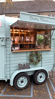 a food truck parked in a parking lot with the door open to it's bar