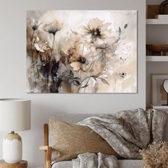 a living room scene with focus on the couch and wall art that has flowers painted on it