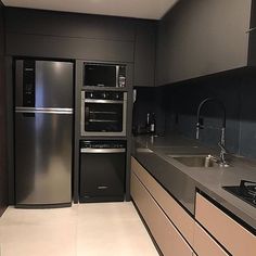 a modern kitchen with stainless steel appliances and counter tops