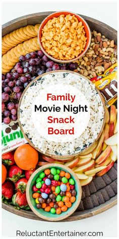 the family movie night snack board is full of snacks, fruit and crackers to enjoy