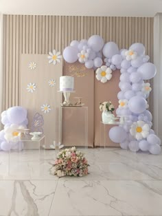 a table topped with lots of balloons and flowers