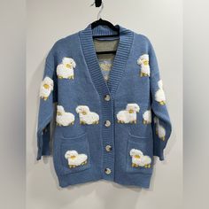 Never Worn Light Blue Sheep Button Up Sweater. The Sweater Is 28in By 19.5in. I’m A Medium To Small And It’s Oversized Could Fit Up To A Large. Sleeves Are 16in Blue Cozy Cardigan With Buttons, Cozy Blue Cardigan With Buttons, Light Blue Button-up Cardigan With Button Closure, Light Blue Cardigan With Button Closure For Winter, Light Blue Sweater With Button Closure For Fall, Spring Blue Sweater With Button Closure, Blue Button-up Sweater With Buttons, Cozy Blue Cardigan With Button Closure, Blue Sweater With Button Closure