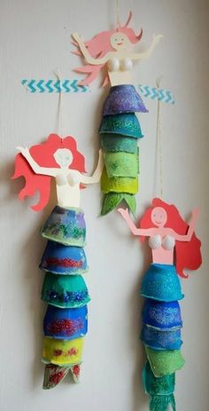 three little mermaids are hanging on the wall