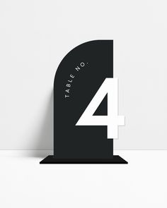 a black and white clock with the number four on it