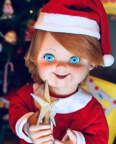 a close up of a doll holding a star