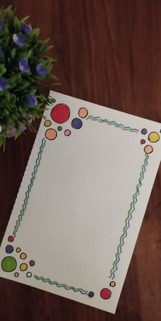 a piece of paper with circles and lines on it next to a potted plant